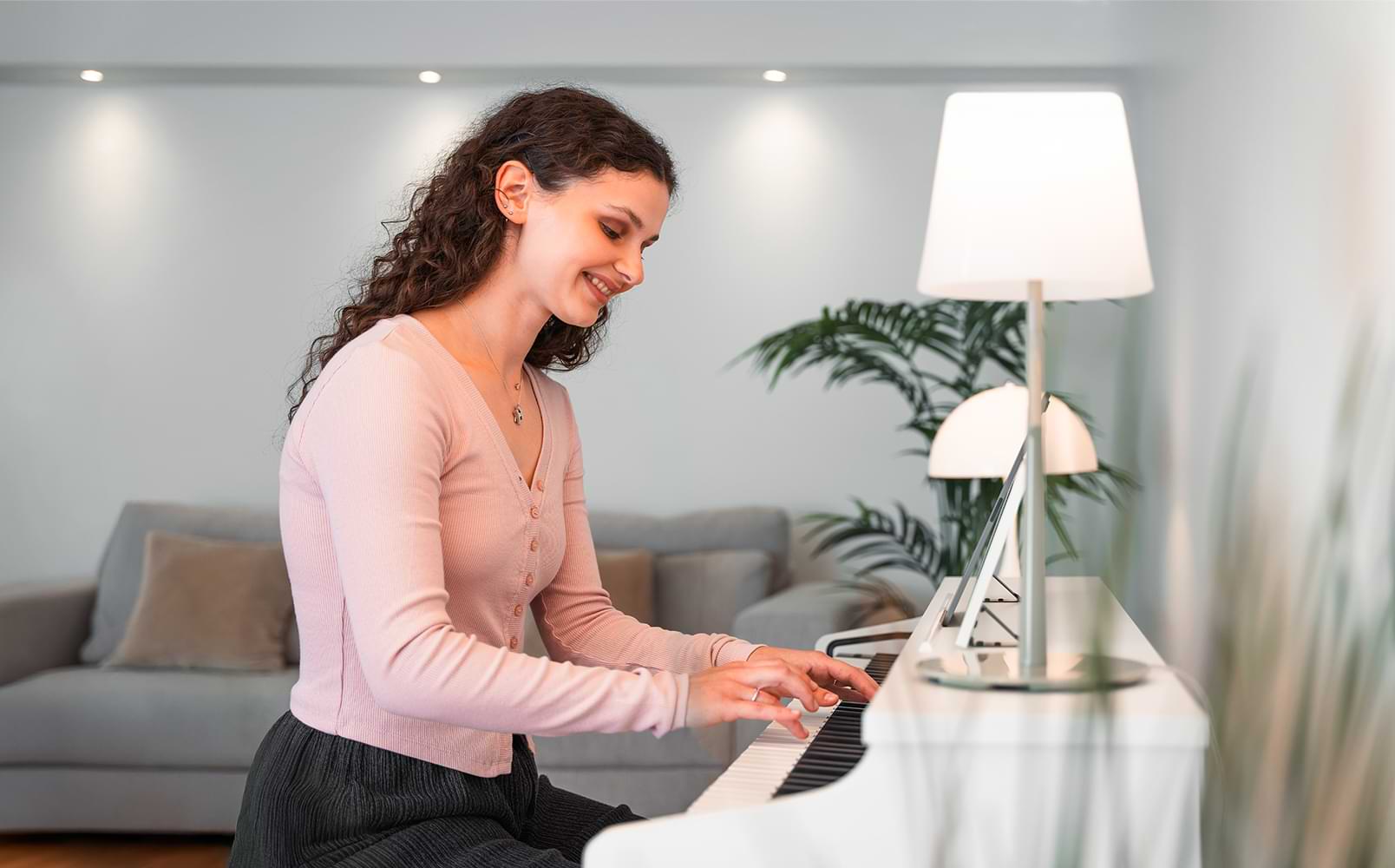 A young woman enjoys playing the CX102 digital piano